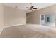 Neutral bedroom features carpet, ceiling fan and a view of the backyard at 11705 Binfield Ct, Orlando, FL 32837