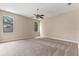 Neutral bedroom features carpet, ceiling fan and a view of the backyard at 11705 Binfield Ct, Orlando, FL 32837