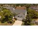 Aerial view showcases the well-maintained exterior with a two-car garage, lush landscaping, and mature trees at 11705 Binfield Ct, Orlando, FL 32837