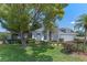 Beautiful home with a lush green lawn, mature trees, and a well-manicured garden at 11705 Binfield Ct, Orlando, FL 32837
