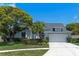 Charming single-Gathering home featuring mature landscaping, a two-car garage, and a well-maintained lawn at 11705 Binfield Ct, Orlando, FL 32837