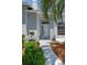 Inviting front entrance with a well-kept garden, mulched flower beds, and a painted walkway at 11705 Binfield Ct, Orlando, FL 32837