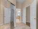 Hallway with mirrored closet doors leading to the bathroom with double doors for added privacy at 11705 Binfield Ct, Orlando, FL 32837