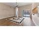 Bright living room featuring wood floors, ceiling fan, and view to the pool at 11705 Binfield Ct, Orlando, FL 32837