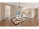 Bright living room featuring wood floors, ceiling fan, and view to the pool at 11705 Binfield Ct, Orlando, FL 32837