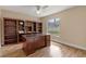 Office with built-in bookcase and large desk overlooking the backyard at 11705 Binfield Ct, Orlando, FL 32837
