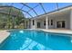 Beautiful, sparkling blue pool with attached spa and screened enclosure, perfect for enjoying the outdoors at 11705 Binfield Ct, Orlando, FL 32837