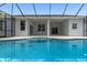 Clear blue pool with a built-in spa and screened enclosure offer a relaxing space and easy access to the house at 11705 Binfield Ct, Orlando, FL 32837