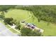 Expansive aerial view showcasing the community park, playground, open green space, and lush wooded areas at 12079 Scrub Palm Ln, Orlando, FL 32824
