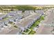 Aerial view of a community featuring modern townhouses, organized streets, and green spaces for recreation at 12079 Scrub Palm Ln, Orlando, FL 32824