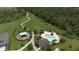 Aerial view of the community pool, clubhouse, playground, and open green space with walking trails at 12079 Scrub Palm Ln, Orlando, FL 32824