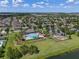 An aerial view showcases the community's amenities, including the pool, playground, and green spaces at 12079 Scrub Palm Ln, Orlando, FL 32824