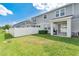 Lush green backyard with a pristine white fence, complemented by a barbecue area for outdoor cooking and entertaining at 12079 Scrub Palm Ln, Orlando, FL 32824