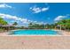 Relax and unwind by the large community pool, with ample seating and shade at 12079 Scrub Palm Ln, Orlando, FL 32824