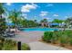 The community pool offers plenty of seating and shade for residents to relax and enjoy the outdoors at 12079 Scrub Palm Ln, Orlando, FL 32824