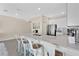 Spacious kitchen with a large island featuring seating, stainless steel appliances, and stylish lighting at 12079 Scrub Palm Ln, Orlando, FL 32824