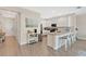 Open-concept kitchen with white cabinetry, stainless steel appliances, and bar seating area at 12079 Scrub Palm Ln, Orlando, FL 32824