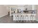 Modern kitchen with a central island, stainless steel appliances, and barstool seating for casual dining at 12079 Scrub Palm Ln, Orlando, FL 32824