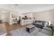 Bright living room with open kitchen, barstool seating, and cozy sofa, ideal for entertaining at 12079 Scrub Palm Ln, Orlando, FL 32824