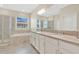 Elegant main bathroom with double sinks, a large mirror, soaking tub, and separate glass shower at 12079 Scrub Palm Ln, Orlando, FL 32824