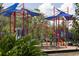 Vibrant community playground with climbing structures, slides, and shade, offering a fun recreational space at 12079 Scrub Palm Ln, Orlando, FL 32824