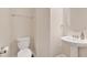 Clean powder room featuring a pedestal sink, toilet, and neutral wall color, perfect for guests at 12079 Scrub Palm Ln, Orlando, FL 32824