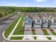 Aerial front view of modern townhouses with well-manicured lawns and neat landscaping at 1341 Wycliffe Way, St Cloud, FL 34771