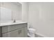 Bathroom featuring a modern vanity with a sleek countertop, a large mirror, and a white toilet at 1341 Wycliffe Way, St Cloud, FL 34771