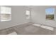 A bright, neutral-toned bedroom with carpet, multiple windows, and white trim at 1341 Wycliffe Way, St Cloud, FL 34771