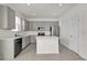 Modern kitchen with stainless steel appliances, gray cabinets, and a center island at 1341 Wycliffe Way, St Cloud, FL 34771