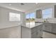 Modern kitchen with an island, gray cabinets, tile floors, and an adjacent dining area at 1341 Wycliffe Way, St Cloud, FL 34771