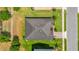 Aerial view of a well-maintained home with a dark roof, surrounded by a lush green lawn and mature landscaping at 14517 Black Lake Preserve St, Winter Garden, FL 34787