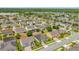 An aerial view of the neighborhood featuring numerous homes, trees and community pond at 14517 Black Lake Preserve St, Winter Garden, FL 34787