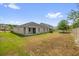 The home has a spacious backyard with green lawn, a covered patio and tall fences at 14517 Black Lake Preserve St, Winter Garden, FL 34787
