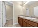 Bathroom with double sinks, wood cabinets, and tile floors creating a clean, functional space at 14517 Black Lake Preserve St, Winter Garden, FL 34787