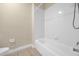 Clean, bright bathroom with a white bathtub, shower, and tiled walls at 14517 Black Lake Preserve St, Winter Garden, FL 34787