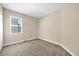 Cozy bedroom with plush carpet, neutral walls, and a bright window at 14517 Black Lake Preserve St, Winter Garden, FL 34787