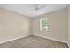 Bedroom with neutral walls, plush carpeting, ceiling fan, and a bright window at 14517 Black Lake Preserve St, Winter Garden, FL 34787