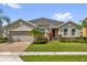 Charming single-story home featuring well-manicured landscaping and a brick-paved driveway at 14517 Black Lake Preserve St, Winter Garden, FL 34787