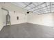 A spacious garage with a painted floor, water heater, and an automatic garage door at 14517 Black Lake Preserve St, Winter Garden, FL 34787