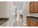 Hallway with tile flooring and cabinetry, connecting the kitchen and other areas of the home at 14517 Black Lake Preserve St, Winter Garden, FL 34787