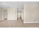 Bright hallway with neutral paint, tiled floors, and multiple doorways at 14517 Black Lake Preserve St, Winter Garden, FL 34787