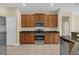 This kitchen showcases stainless steel appliances, granite countertops, and ample wood cabinet storage at 14517 Black Lake Preserve St, Winter Garden, FL 34787