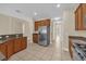 Modern kitchen with stainless steel appliances, wooden cabinets, and granite countertops at 14517 Black Lake Preserve St, Winter Garden, FL 34787