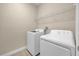 Laundry room with tiled floor, washer, dryer, and overhead wire shelving at 14517 Black Lake Preserve St, Winter Garden, FL 34787