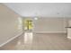 Living area showcasing tiled floors, neutral walls, and access to the backyard via sliding glass door at 14517 Black Lake Preserve St, Winter Garden, FL 34787