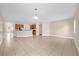 Open-concept living room with views to the kitchen and neutral paint tones at 14517 Black Lake Preserve St, Winter Garden, FL 34787