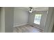 Bedroom features a ceiling fan, large window, and neutral walls at 1472 6Th Ave, Deland, FL 32724