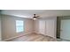 Bedroom with ceiling fan, large window, and spacious closet at 1472 6Th Ave, Deland, FL 32724