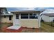 View of an enclosed rear porch addition to the main home, featuring a solid roof and siding at 1472 6Th Ave, Deland, FL 32724